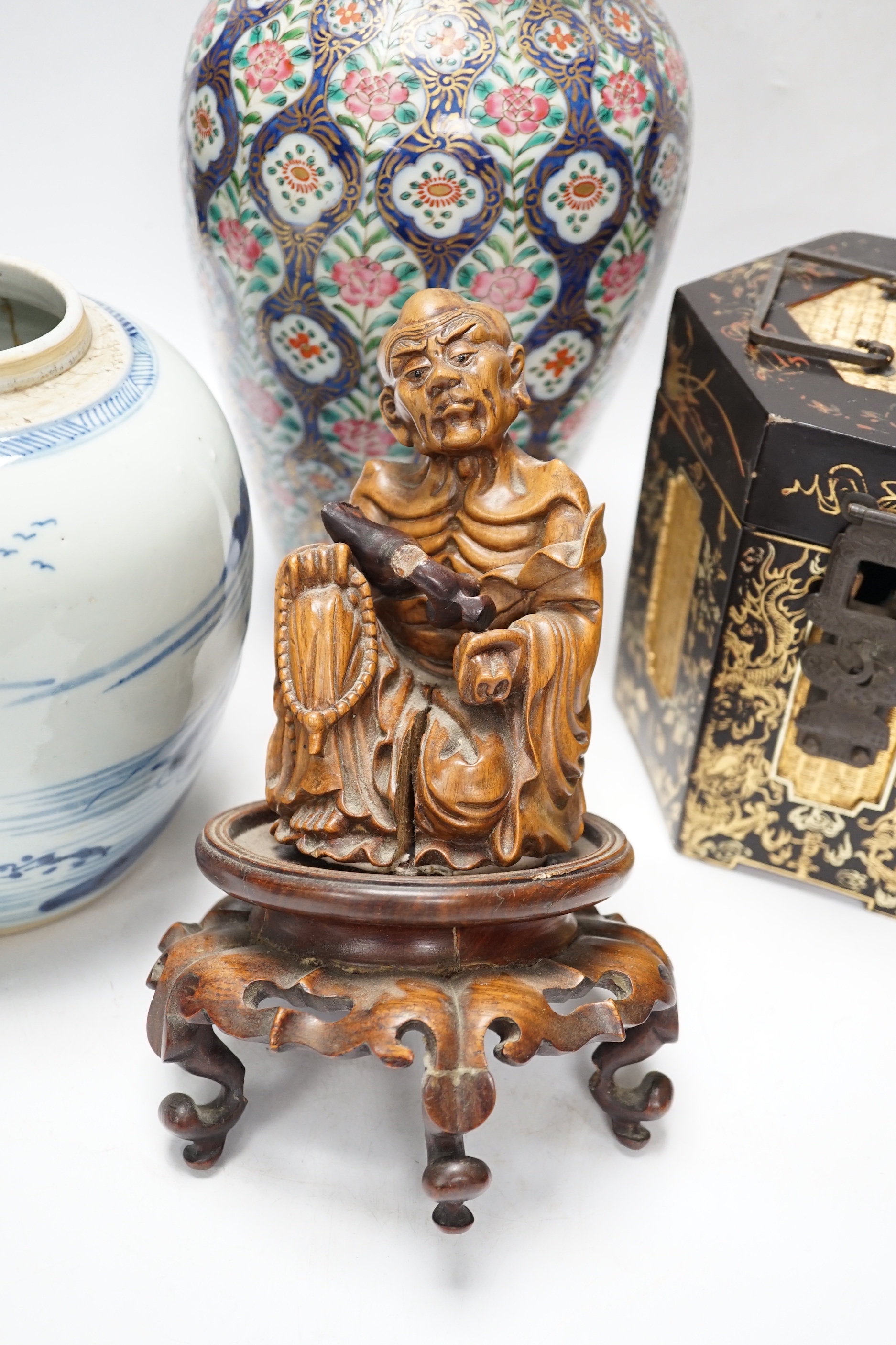 A group of Chinese items including a hardwood carving of luohan, an 18th century blue and white jar, a lacquer box, etc.
